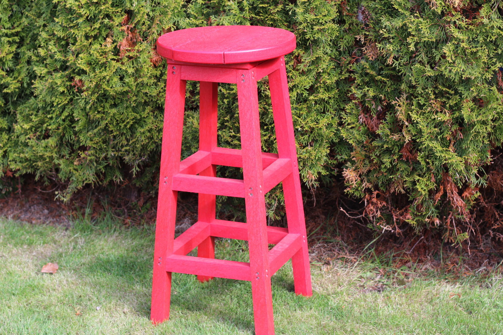 Red recycled plastic bar stool product shot on grass | Mobek