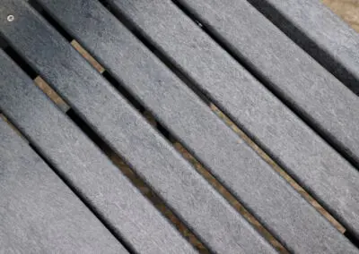 Angled close-up of grey recycled plastic outdoor furniture slat surface | Mobek