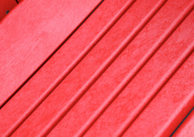 Diagonal close-up of red recycled plastic slats on Mobek garden furniture