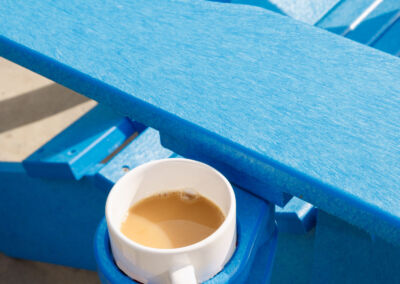 Close-up of blue recycled plastic table surface with a white coffee mug – Mobek